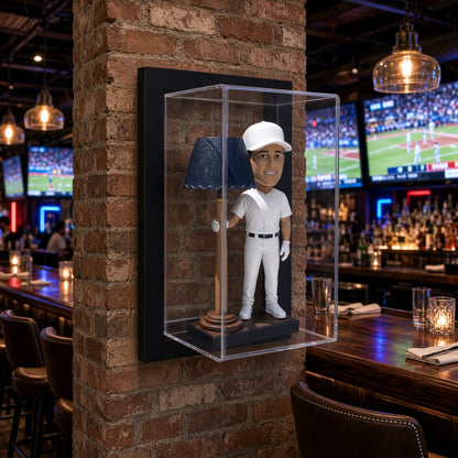 Framed bobblehead display case mounted on a brick wall in a sports bar