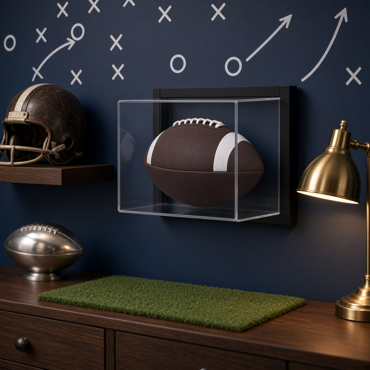 Framed football display case on a chalkboard play-diagram wall in a game room