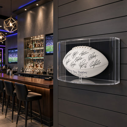 Curved football display case on a dark wall in a sports bar