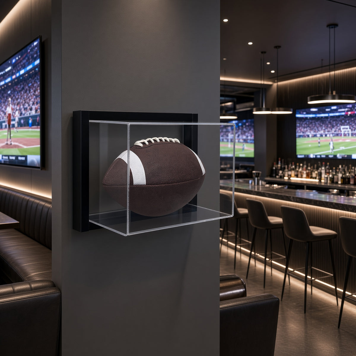 Framed football display case on a dark wall in a sports bar