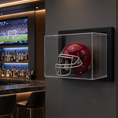 Framed mini helmet case on a dark wall in a sports bar