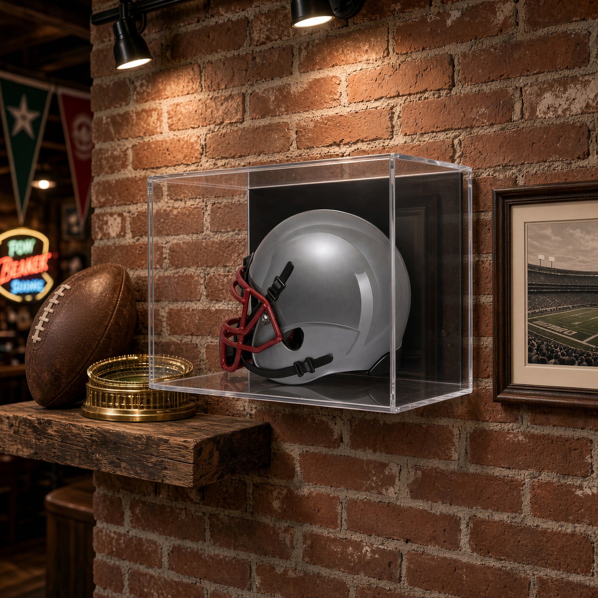 Mini helmet case on a brick wall above a shelf with a football