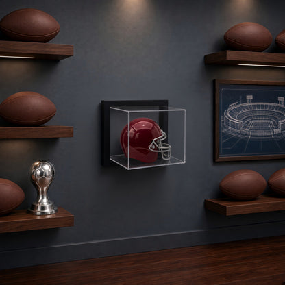 Framed mini helmet case on a gray wall above a shelf of footballs