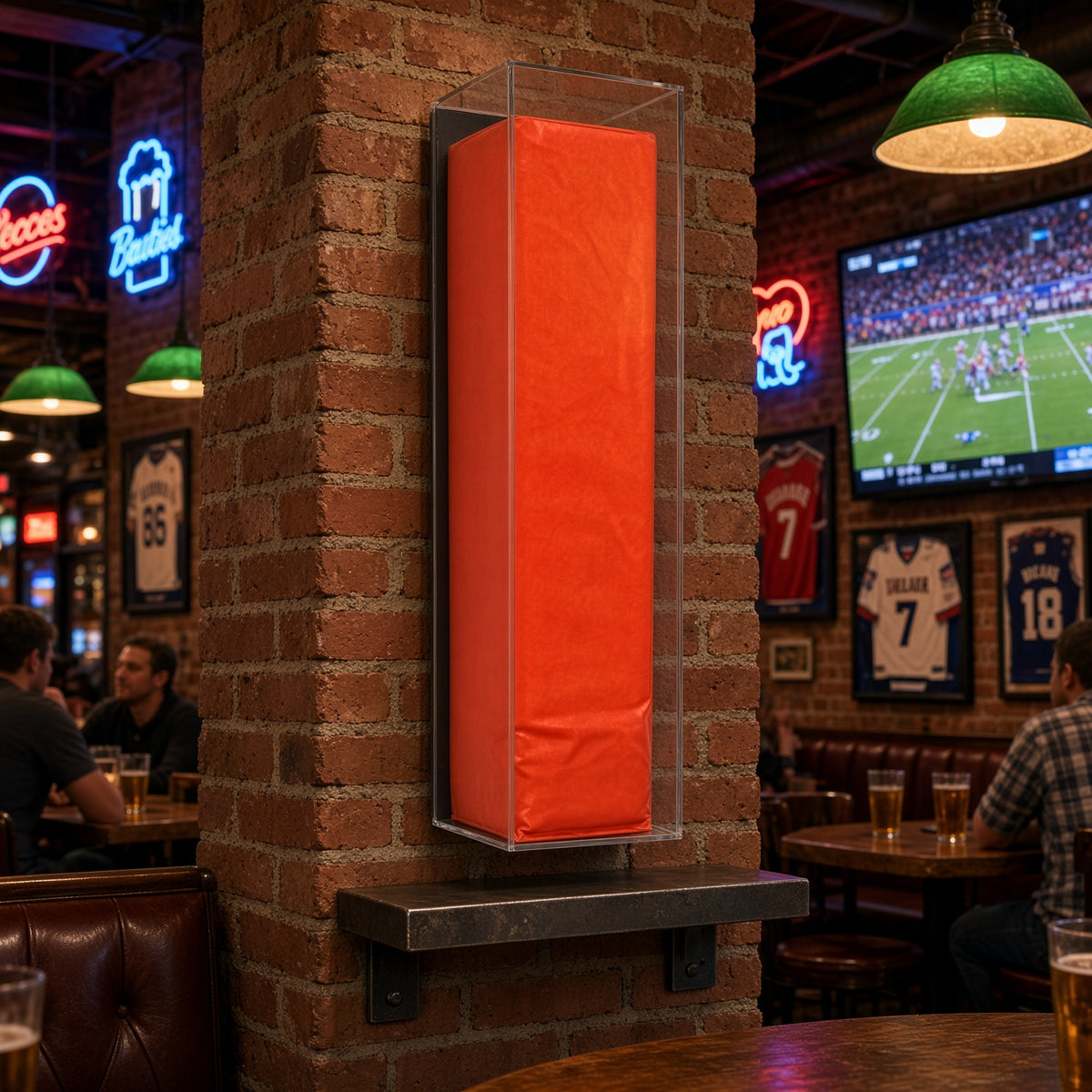 Football pylon case mounted on a brick wall in a sports bar