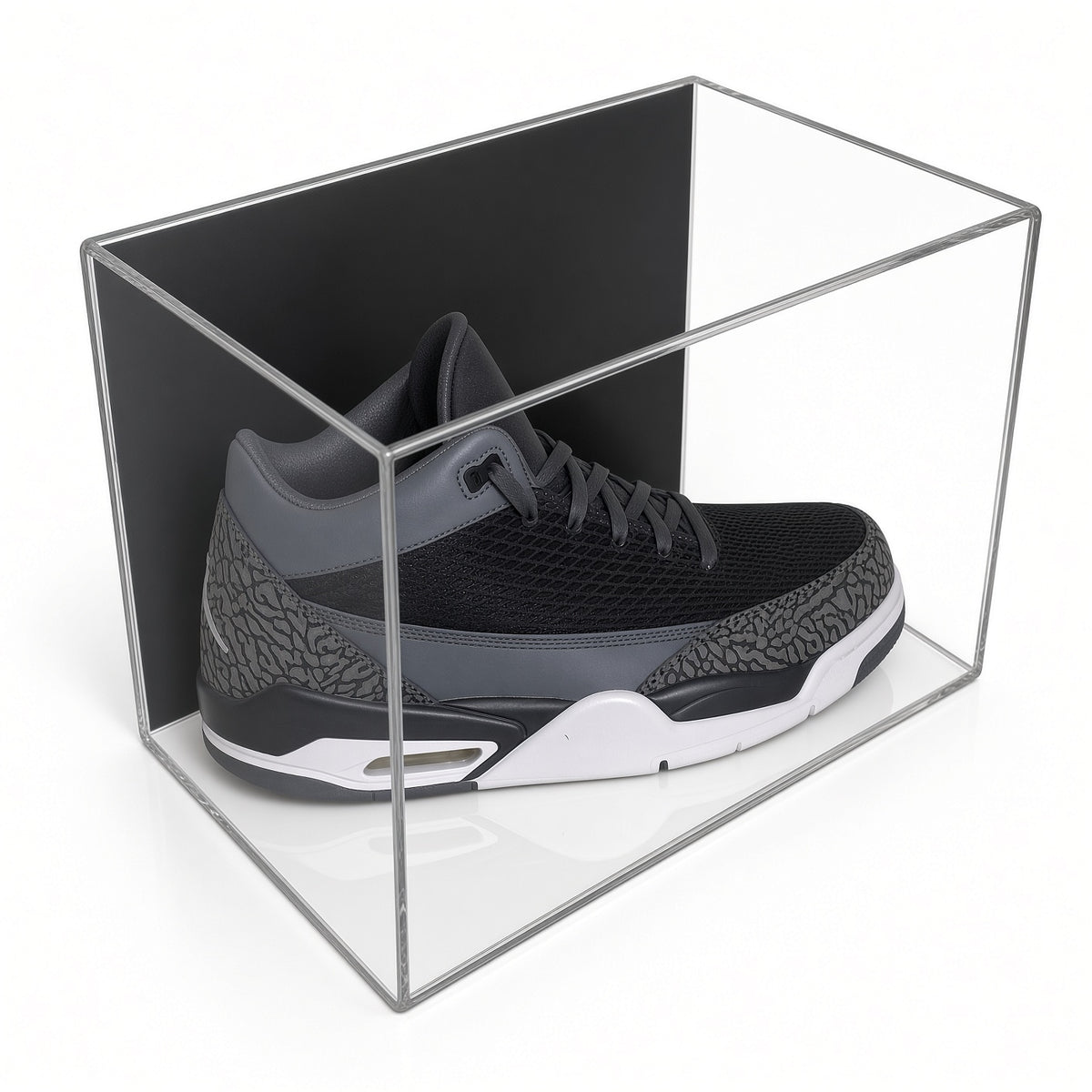 Acrylic wall mount case with a black back holding a single gray sneaker