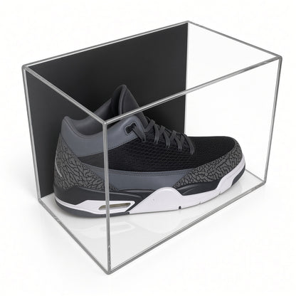 Acrylic wall mount case with a black back holding a single gray sneaker