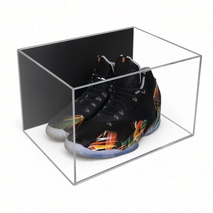 Acrylic wall mount case with a black back holding a pair of black sneakers