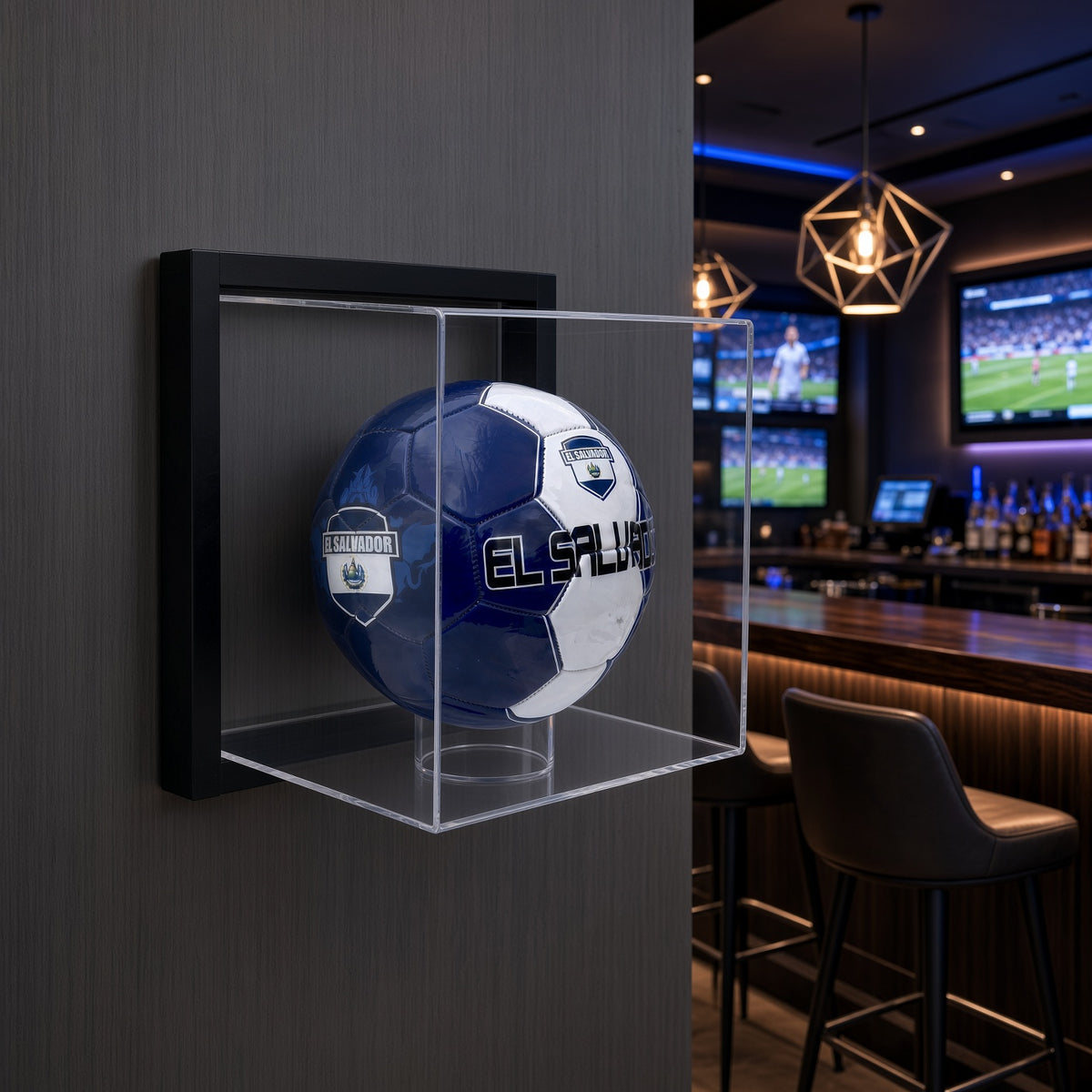 Framed soccer ball display case mounted on a dark wall in a sports bar