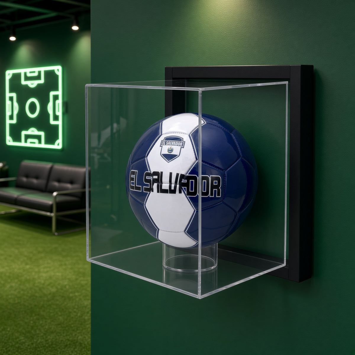 Framed soccer ball case on a green wall beside a neon soccer field sign