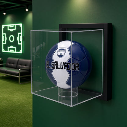 Framed soccer ball case on a green wall beside a neon soccer field sign