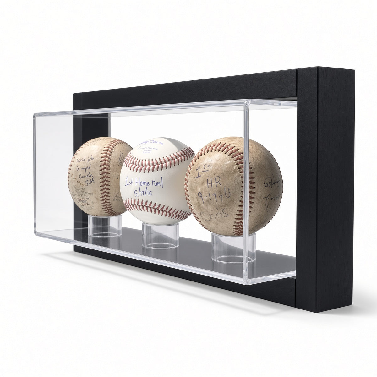Angled view of three baseballs resting on rings in the framed case