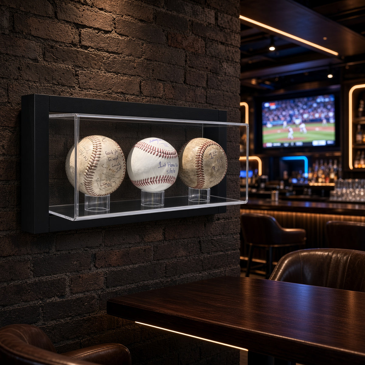 Framed 3 baseball display case on a brick wall in a sports bar
