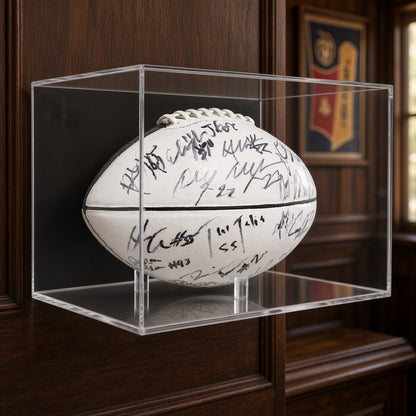 Football display case with a signed football on a wood-paneled wall