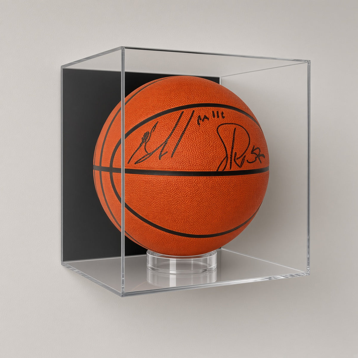 Basketball case with a signed ball mounted on a plain gray wall