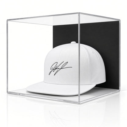 Acrylic wall mount case with a black back holding a signed white baseball cap
