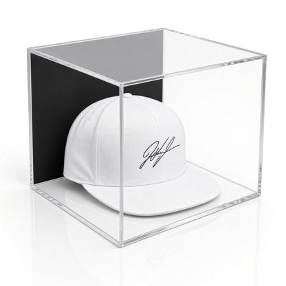 Angled view of a signed white cap in the wall mount hat case